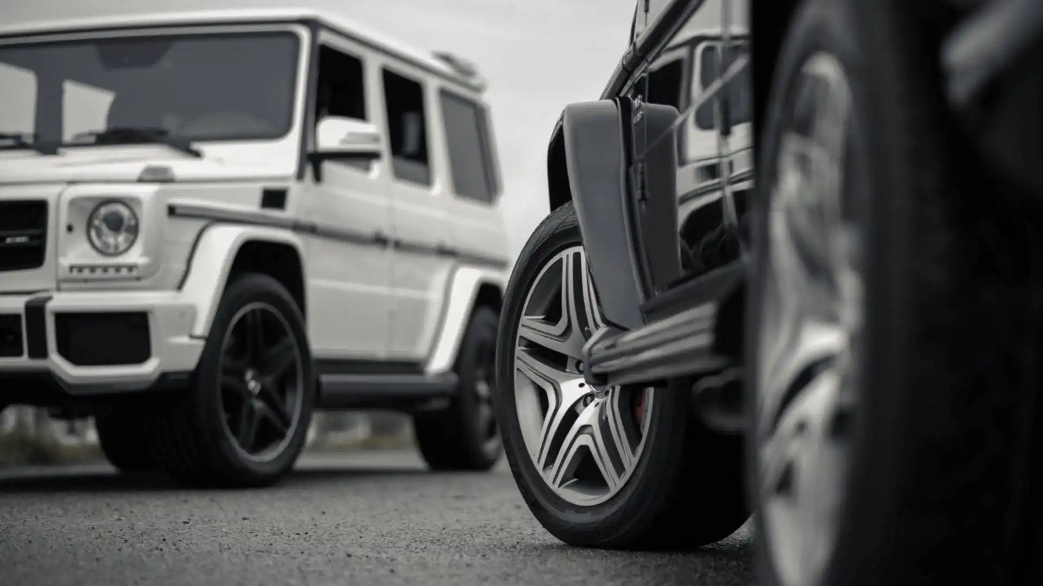 Mercedes-Benz G-Class SUV with black wheels photographed from a low angle.